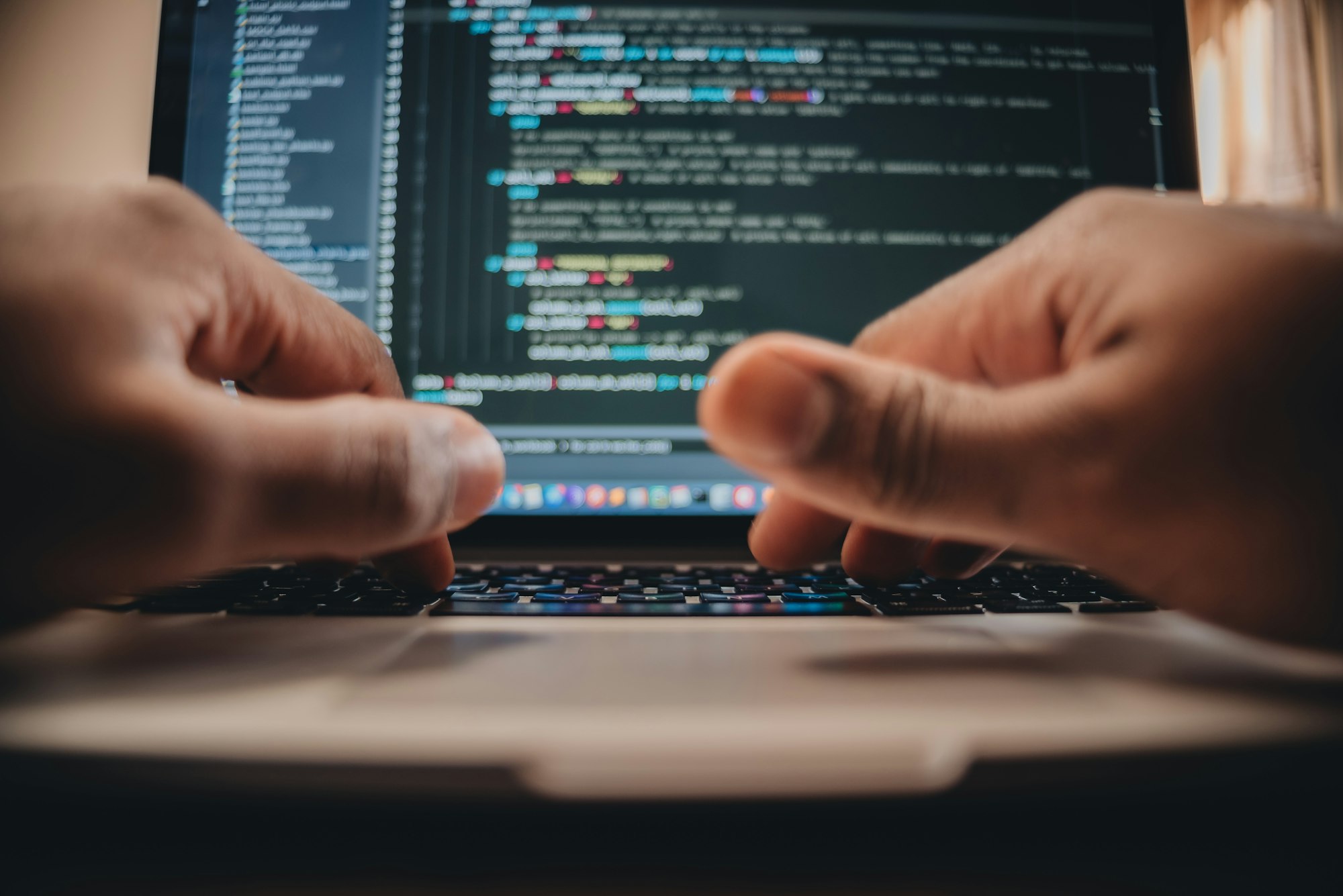 African American man sitting in front of computer coding, programming, web developer